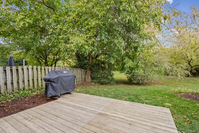 a wooden bench sitting in middle of a yard
