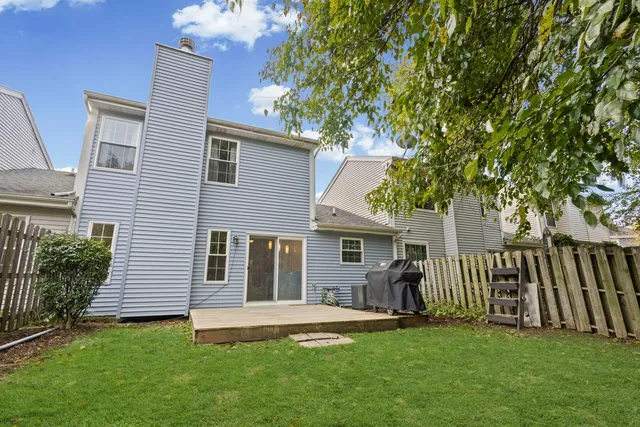 a front view of a house with a garden and yard