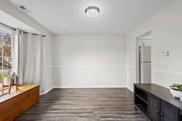 a view of room with window and hardwood floor