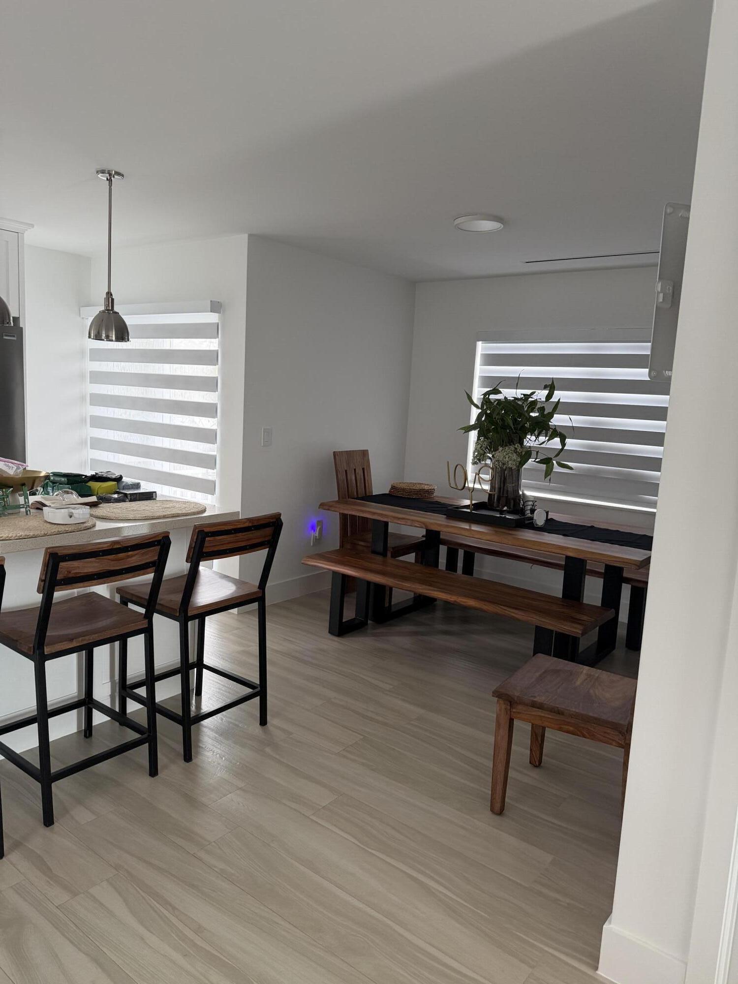 94825 Overseas Highway, Unit 8 Key Largo, FL 33037 - Photo 5 of 12 a room with furniture and a wooden floor