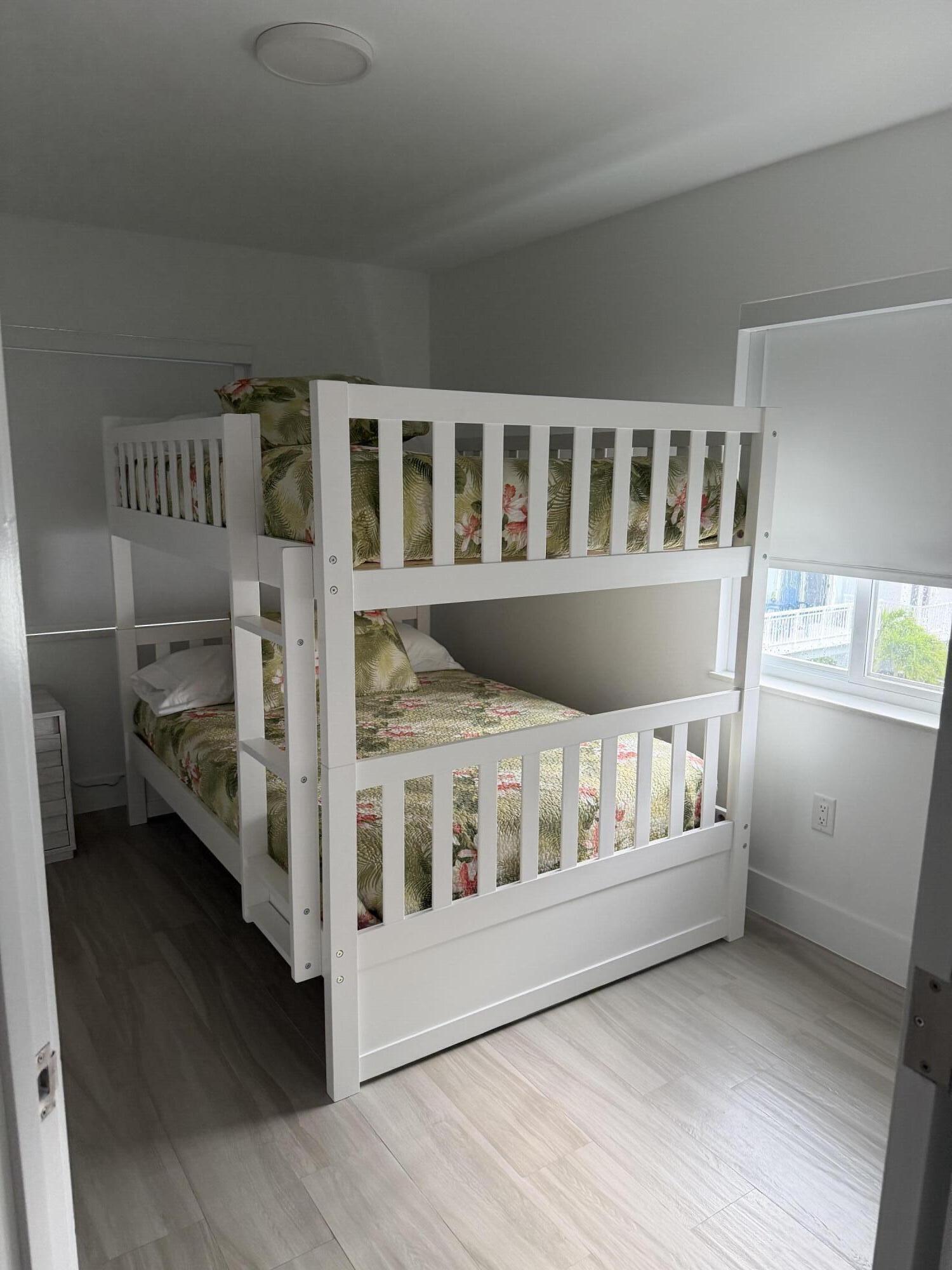 94825 Overseas Highway, Unit 8 Key Largo, FL 33037 - Photo 10 of 12 a view of an empty room with a baby crib