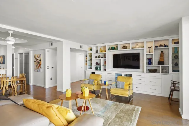 a living room with furniture flat screen tv and white floor