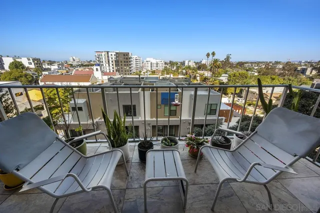 a view of a balcony with chairs and a table