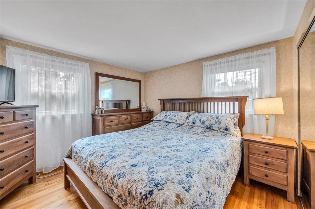 83 Loomis Drive Chicopee, MA 01020 - Photo 14 of 40 a bedroom with a bed and wooden floor