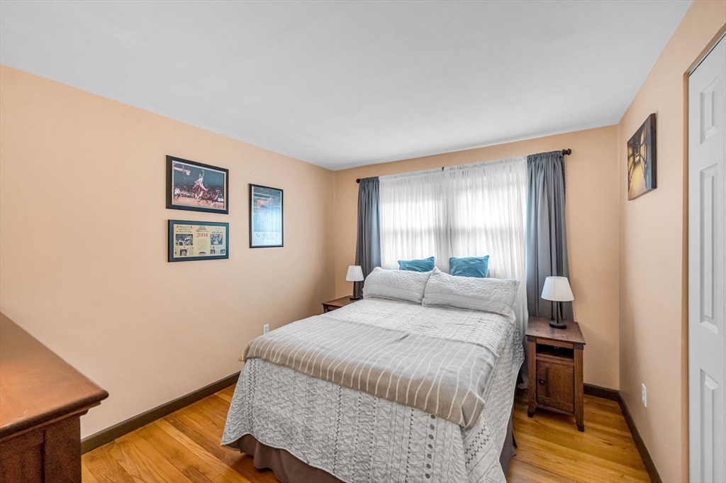 83 Loomis Drive Chicopee, MA 01020 - Photo 18 of 40 a bedroom with a bed and wooden floor