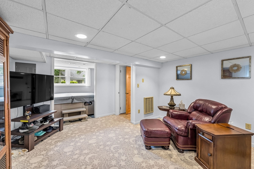 83 Loomis Drive Chicopee, MA 01020 - Photo 25 of 40 a living room with furniture a window and a flat screen tv