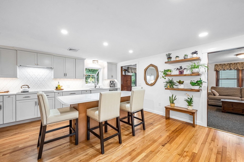 83 Loomis Drive Chicopee, MA 01020 - Photo 3 of 40 a living room with furniture and a kitchen view with wooden floor