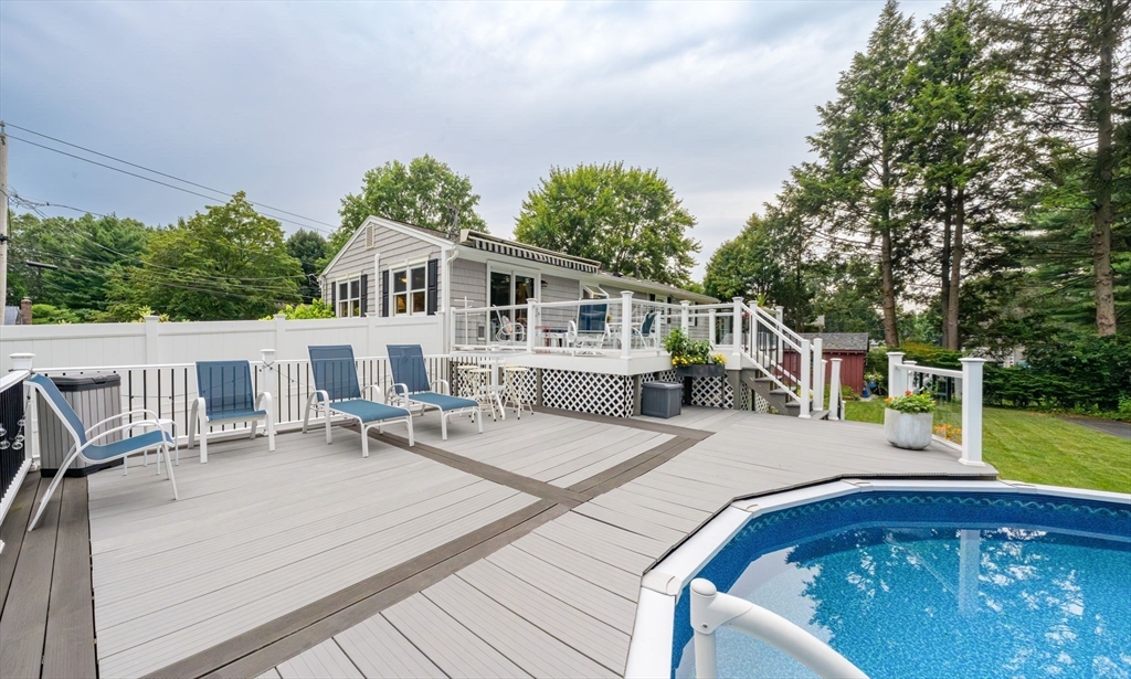 83 Loomis Drive Chicopee, MA 01020 - Photo 33 of 40 a view of a patio with table and chairs with wooden floor and fence