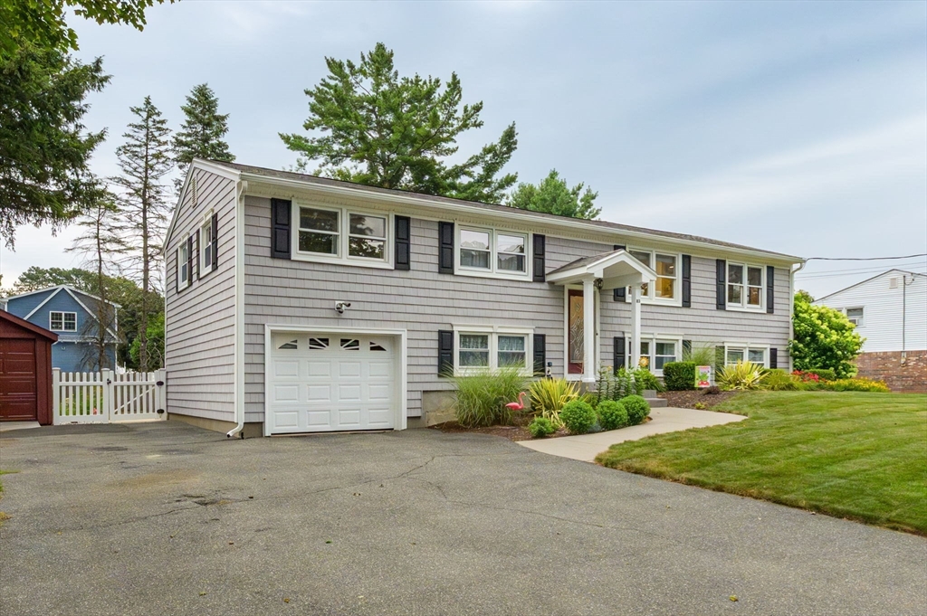 83 Loomis Drive Chicopee, MA 01020 - Photo 38 of 40 a front view of a house with a yard and garage