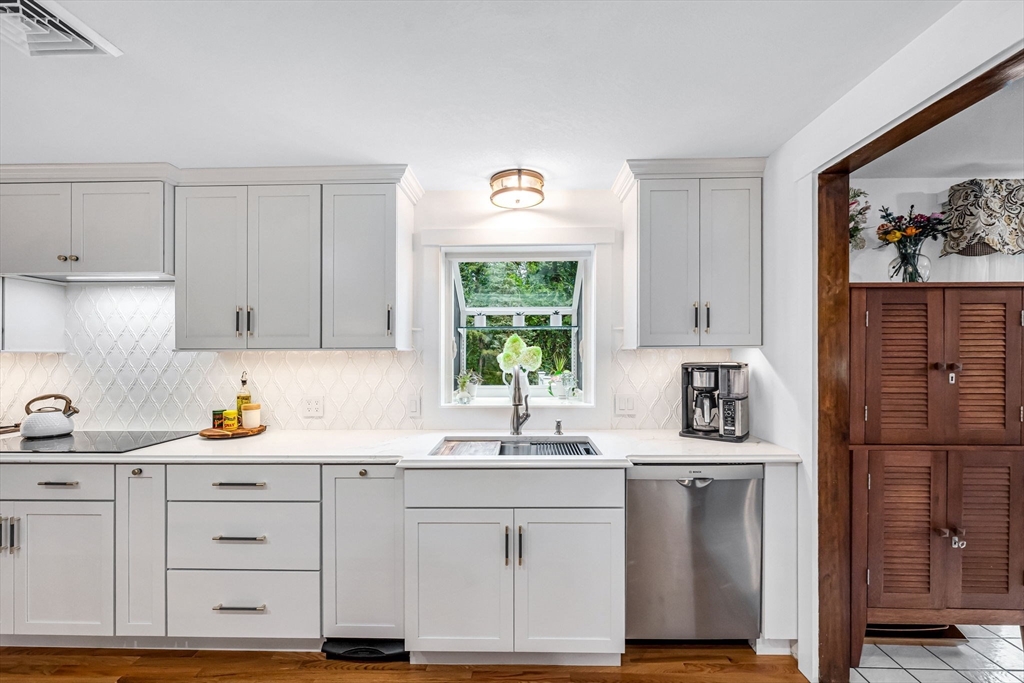83 Loomis Drive Chicopee, MA 01020 - Photo 7 of 40 a kitchen with white cabinets and window