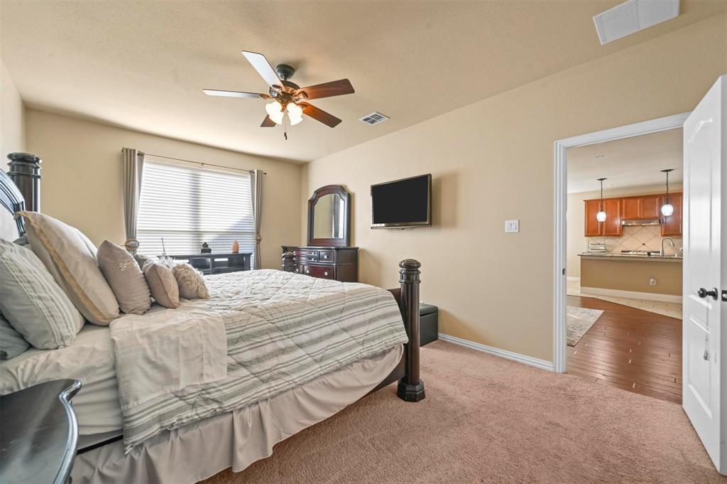 14815 Frisco Ranch Drive Little Elm, TX 75068 - Photo 15 of 40 a bedroom with a bed a window and a flat screen television