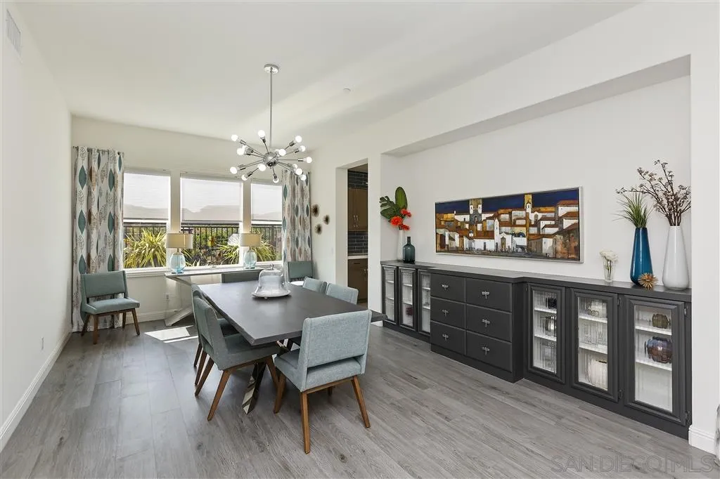 4702 Crespi Court Carlsbad, CA 92010 - Photo 13 of 39 a view of a dining room with furniture window and wooden floor