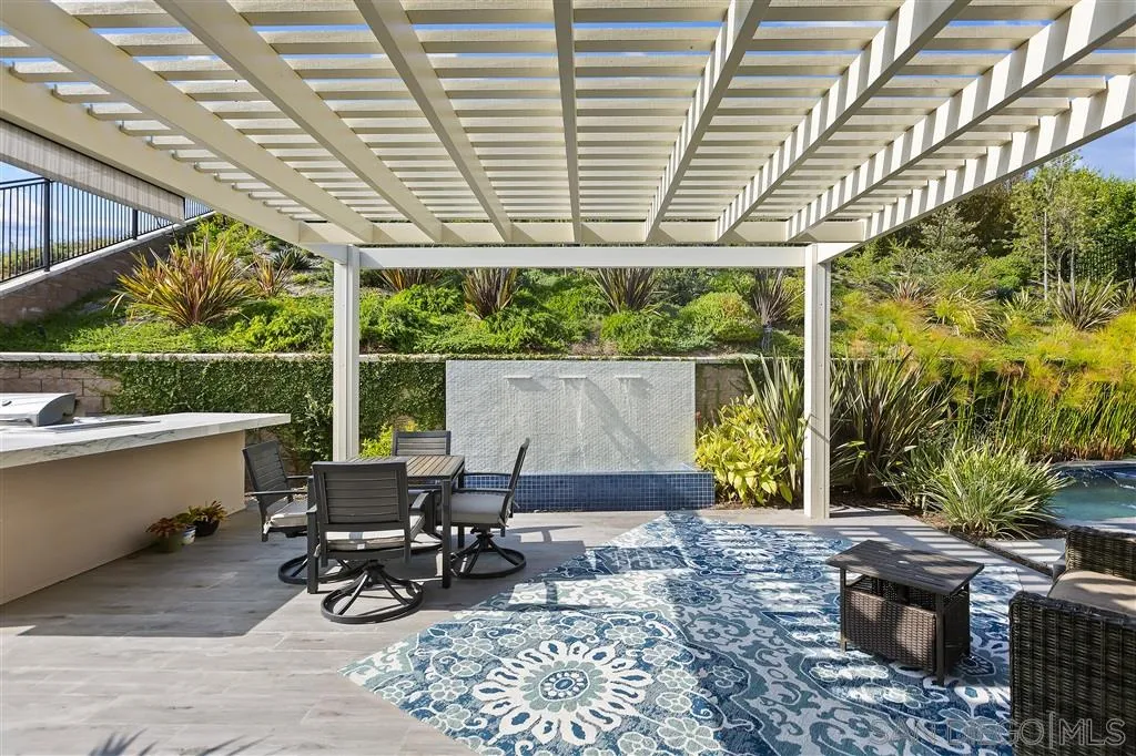 4702 Crespi Court Carlsbad, CA 92010 - Photo 16 of 39 a living room with patio furniture and a grill