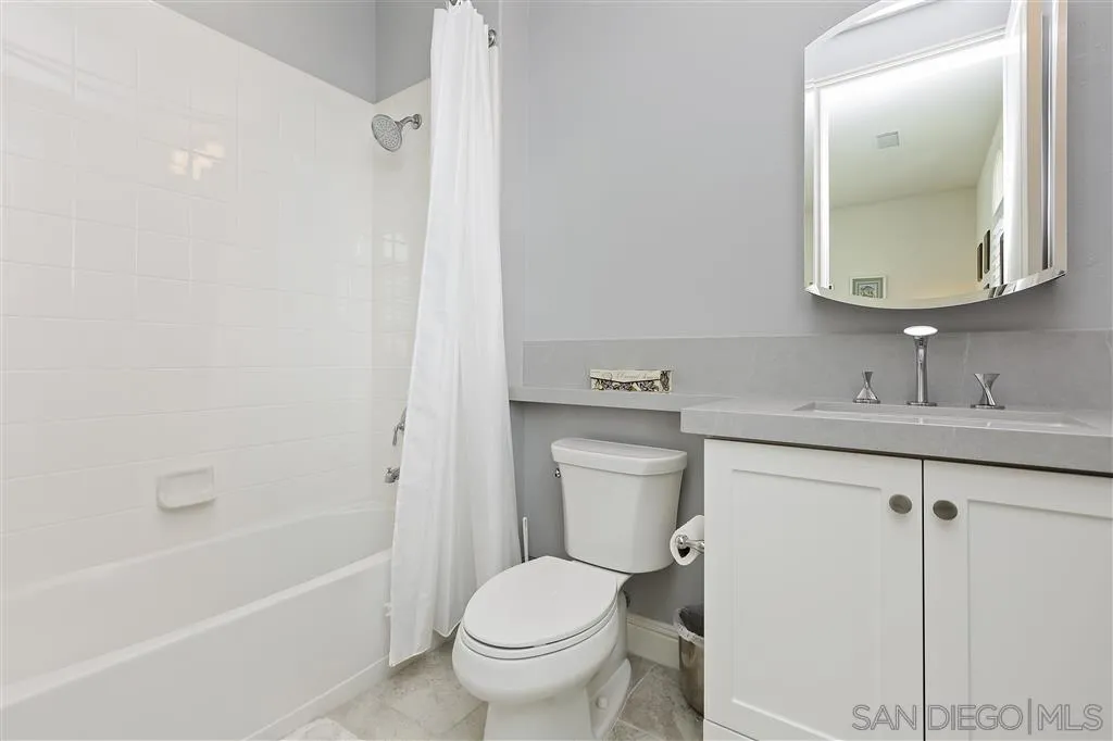 4702 Crespi Court Carlsbad, CA 92010 - Photo 25 of 39 a bathroom with a toilet sink and mirror