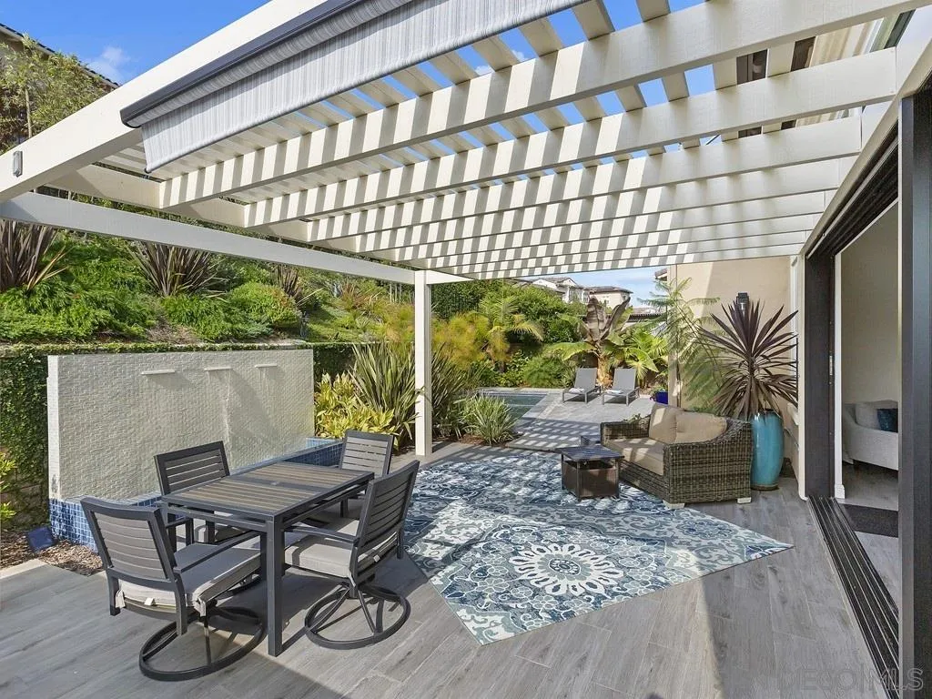 4702 Crespi Court Carlsbad, CA 92010 - Photo 33 of 39 a patio with glass top table and chairs