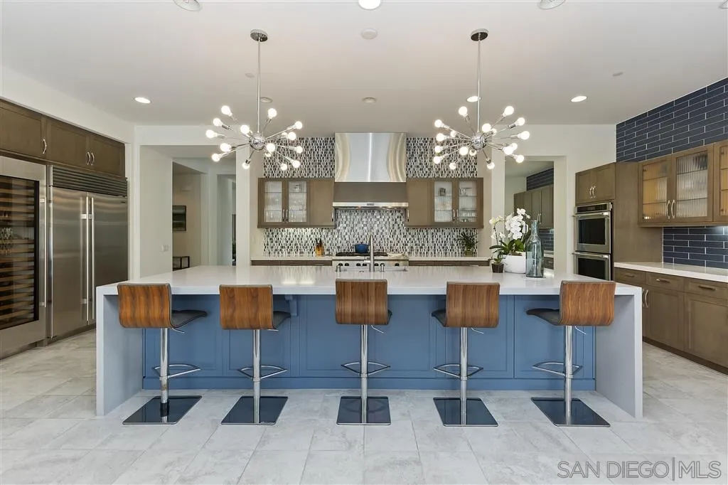 4702 Crespi Court Carlsbad, CA 92010 - Photo 5 of 39 a dining room with furniture a chandelier and kitchen view