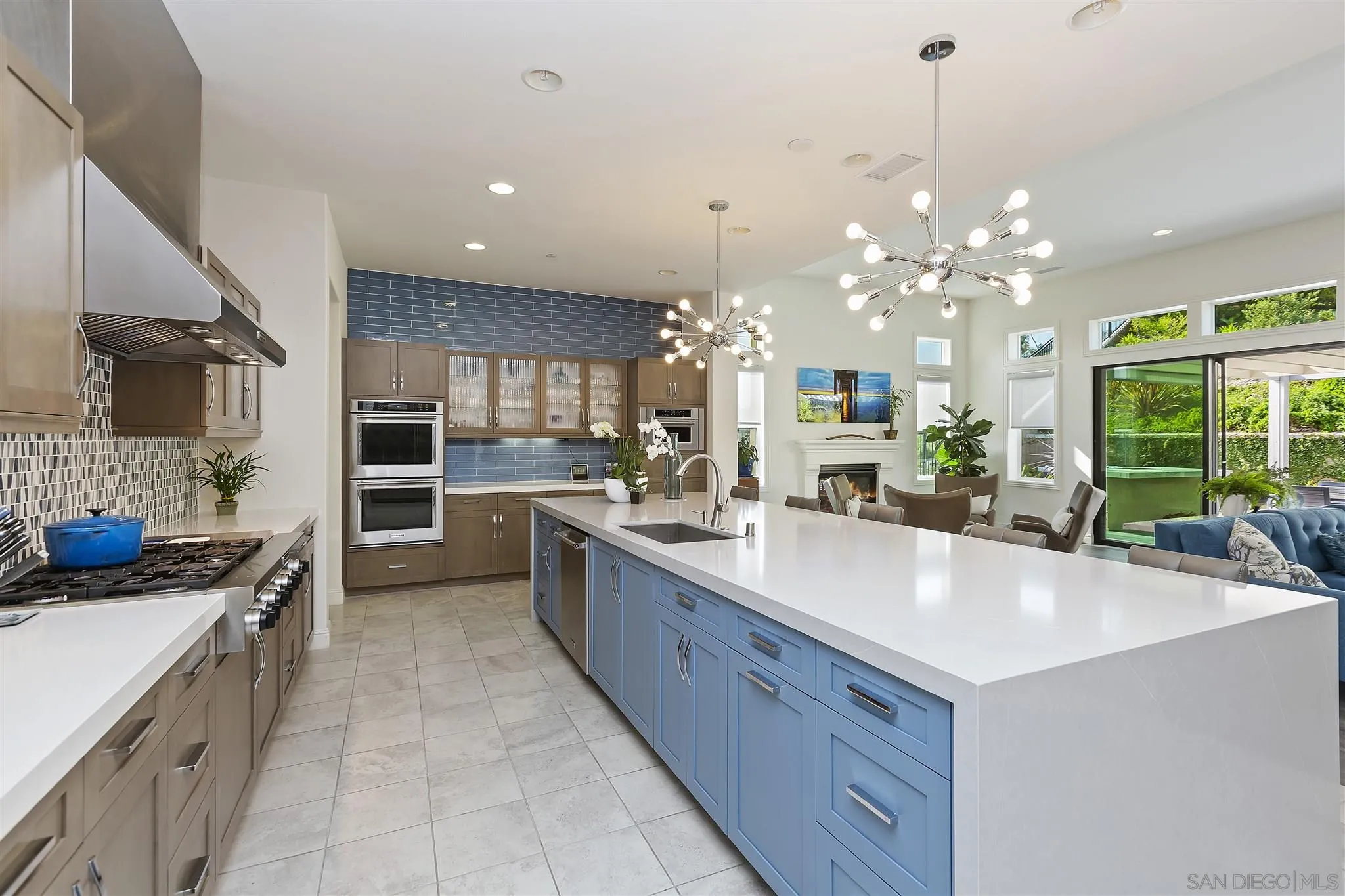 4702 Crespi Court Carlsbad, CA 92010 - Photo 8 of 39 a large white kitchen with kitchen island granite countertop a large counter top stainless steel appliances and cabinets