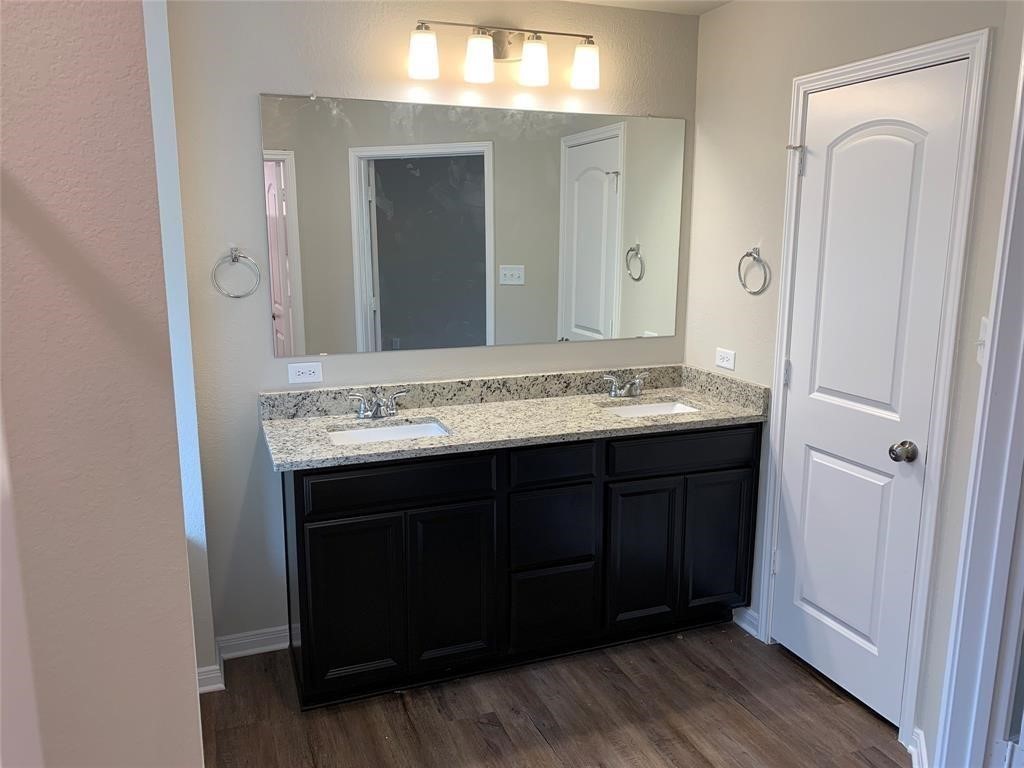 994 Arbor Crossing Conroe, TX 77303 - Photo 7 of 9 a bathroom with a granite countertop sink and a mirror
