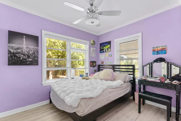 a bedroom with a bed a dresser and a window