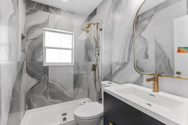 a bathroom with a sink toilet and shower