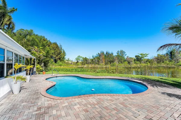 a view of a swimming pool and a yard