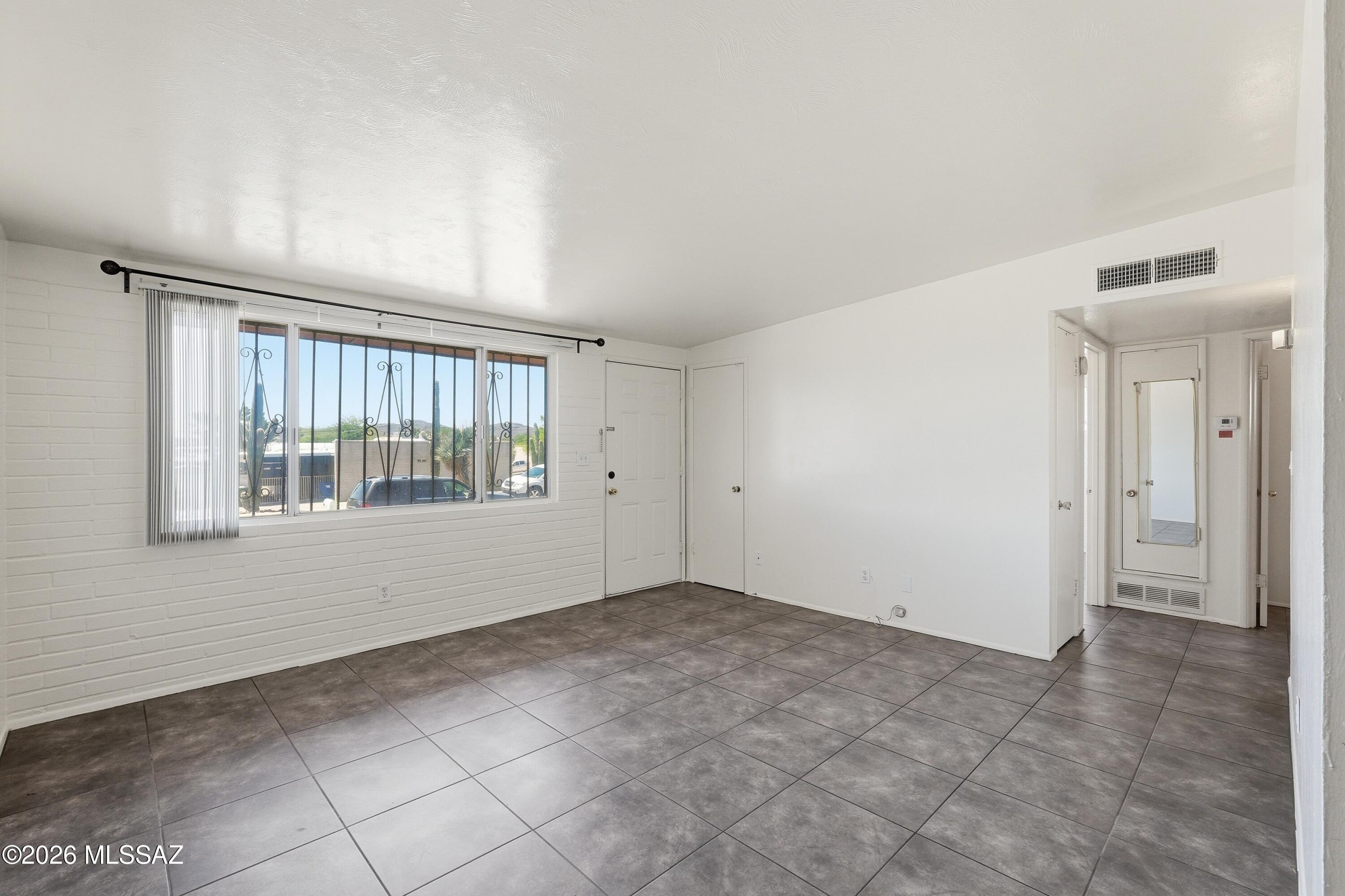 1808 West Caravelle Road Tucson, AZ 85713 - Photo 5 of 38 a view of an empty room with a window