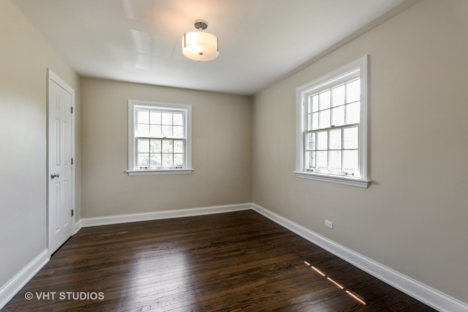 1729 Berkeley Road Highland Park, IL 60035 - Photo 16 of 25 an empty room with wooden floor and windows
