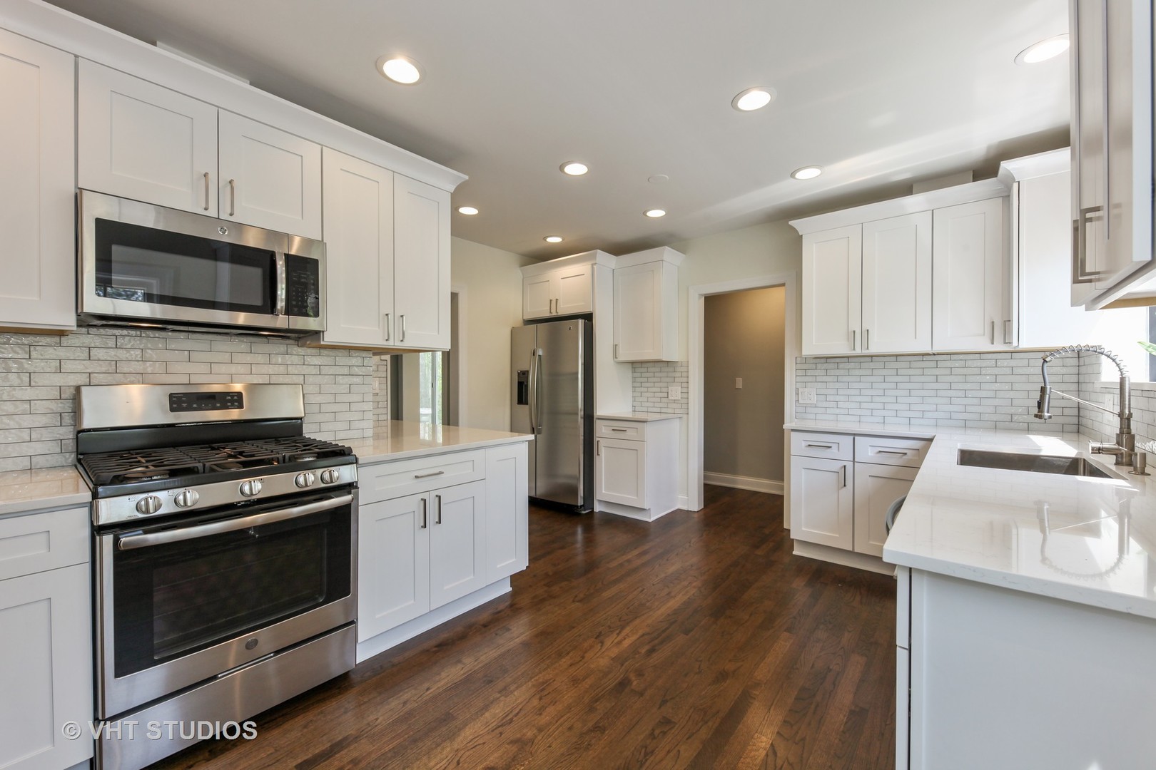 1729 Berkeley Road Highland Park, IL 60035 - Photo 4 of 25 a kitchen with stainless steel appliances a stove microwave and sink