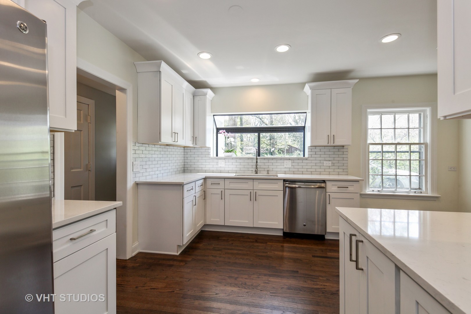 1729 Berkeley Road Highland Park, IL 60035 - Photo 5 of 25 a kitchen with granite countertop white cabinets and wooden floor