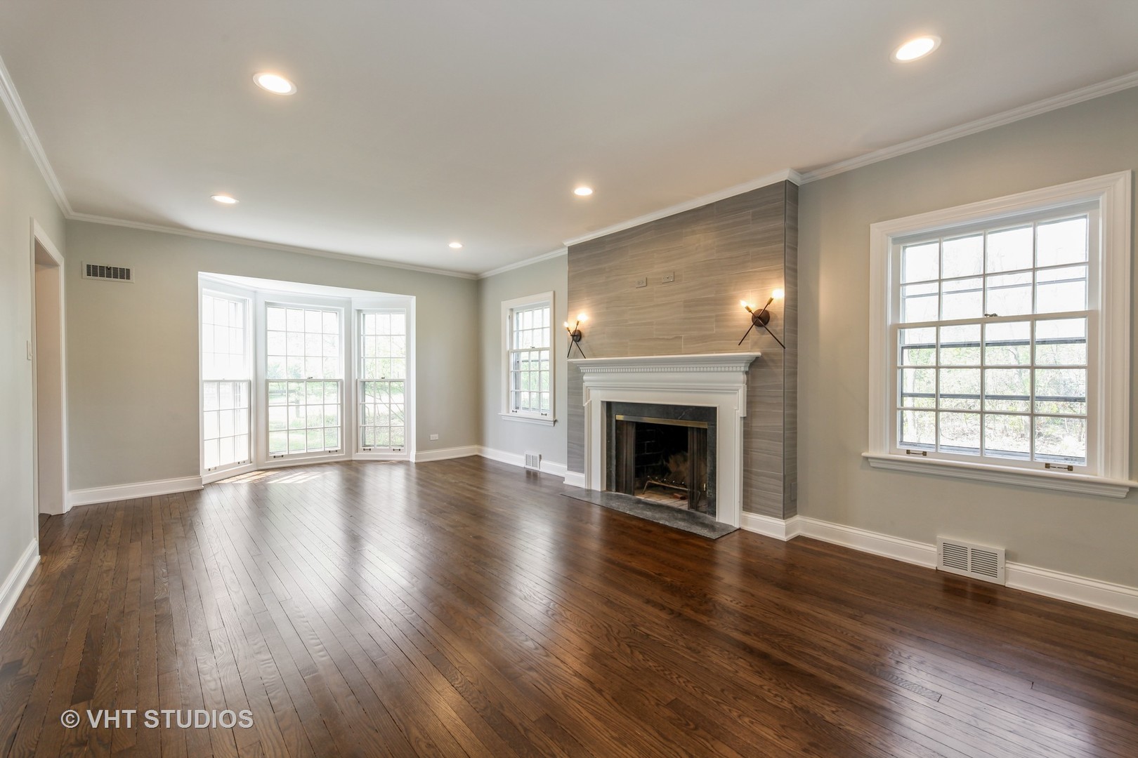 1729 Berkeley Road Highland Park, IL 60035 - Photo 10 of 25 an empty room with wooden floor fireplace and windows