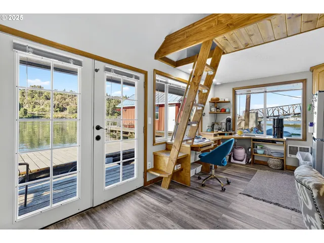 a room with furniture pool table and large windows