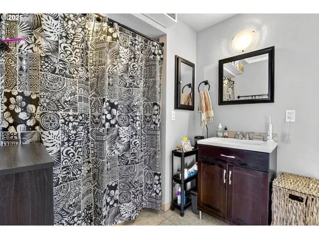 a bathroom with a sink vanity granite and toilet