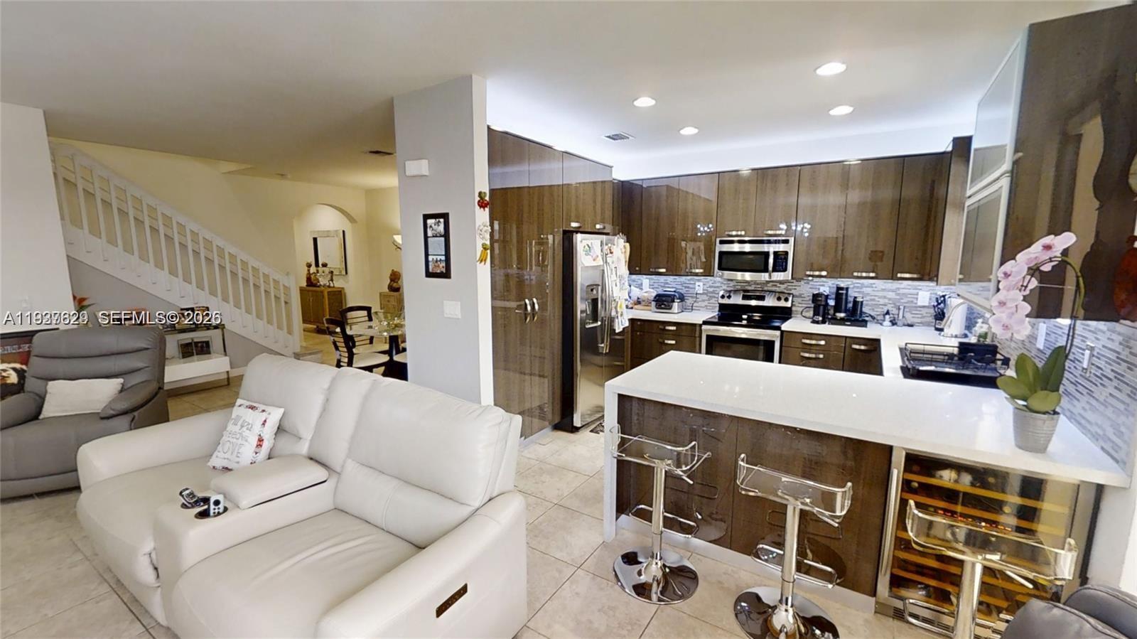 a living room with furniture a flat screen tv and a table