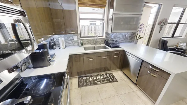 a kitchen with a sink stove and cabinets
