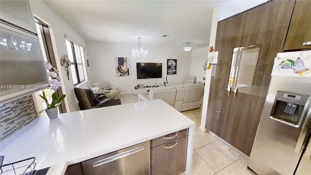 a kitchen with stainless steel appliances a refrigerator sink and microwave