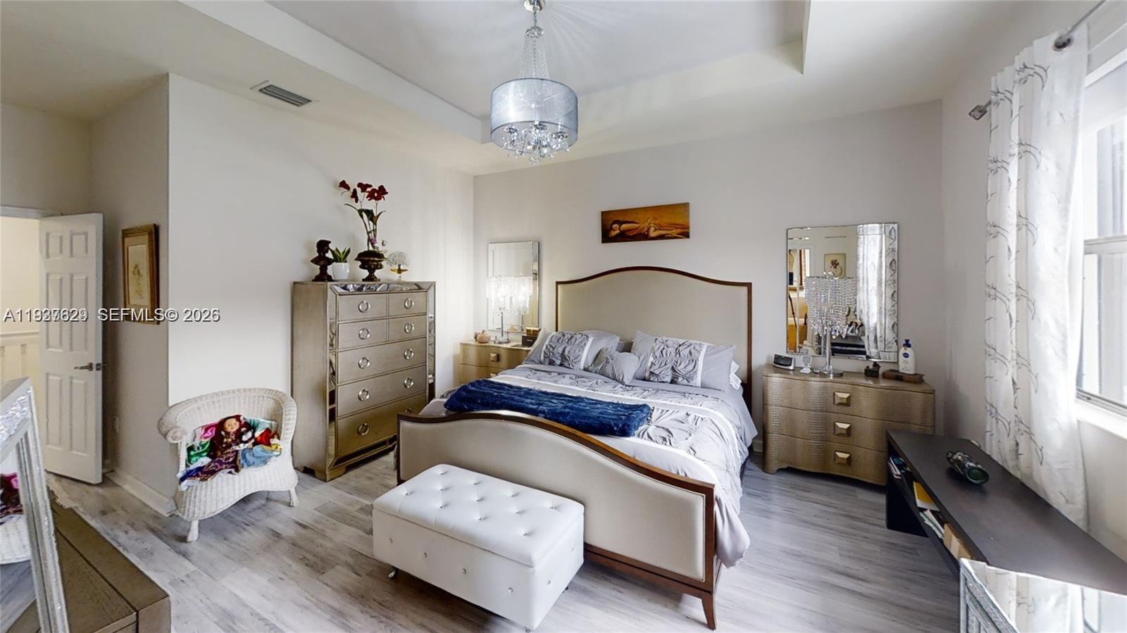 4231 Southwest 165th Court Miami, FL 33185 - Photo 20 of 39 a bedroom with a bed and wooden floor