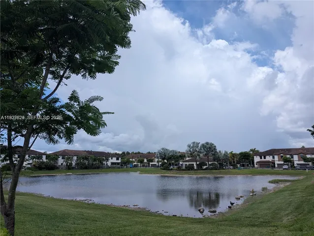 a view of a lake with houses in the back