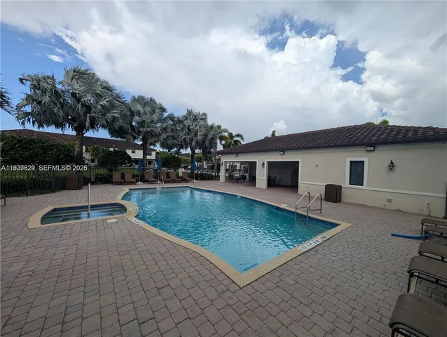 a swimming pool with outdoor seating and yard