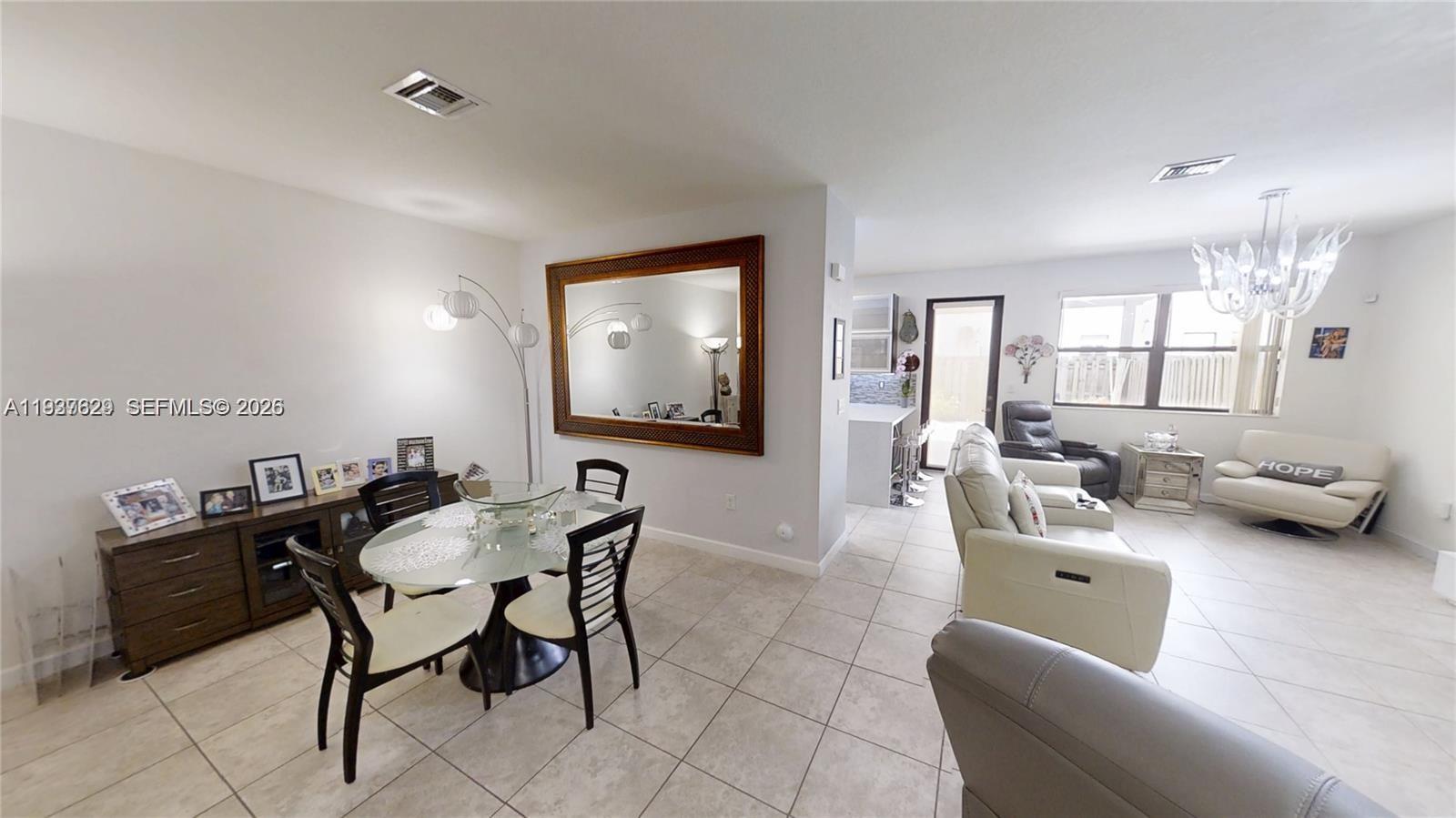 4231 Southwest 165th Court Miami, FL 33185 - Photo 6 of 39 a living room with furniture and a flat screen tv