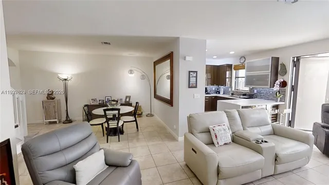 a dining room with furniture and a view of kitchen