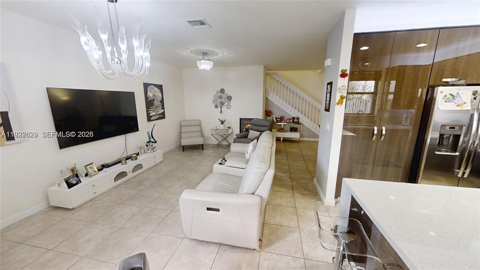 4231 Southwest 165th Court Miami, FL 33185 - Photo 9 of 39 a living room with furniture and a flat screen tv