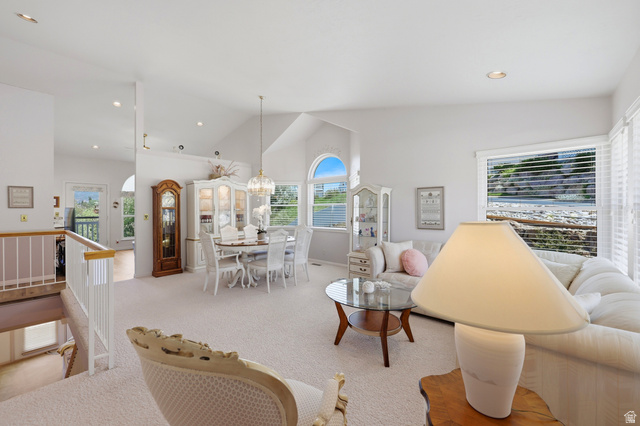 3766 Cardiff Circle Bountiful, UT 84010 - Photo 8 of 46 Bright living space featuring vaulted ceilings, a large picture window, recessed lighting, and a neutral carpet