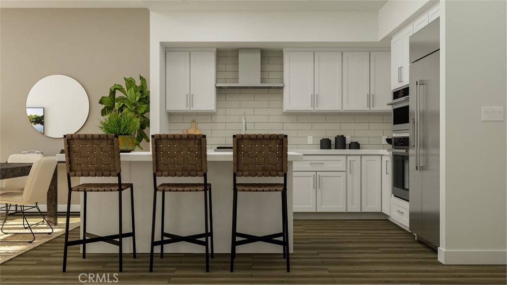 a kitchen with cabinets and chairs