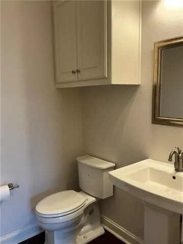 a bathroom with a sink a toilet and mirror