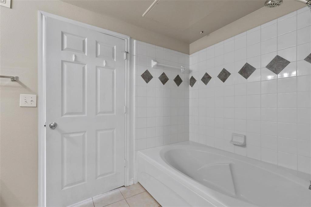 3102 Kings Road, Unit 1303 Dallas, TX 75219 - Photo 9 of 25 a bathroom with a bathtub and a shower