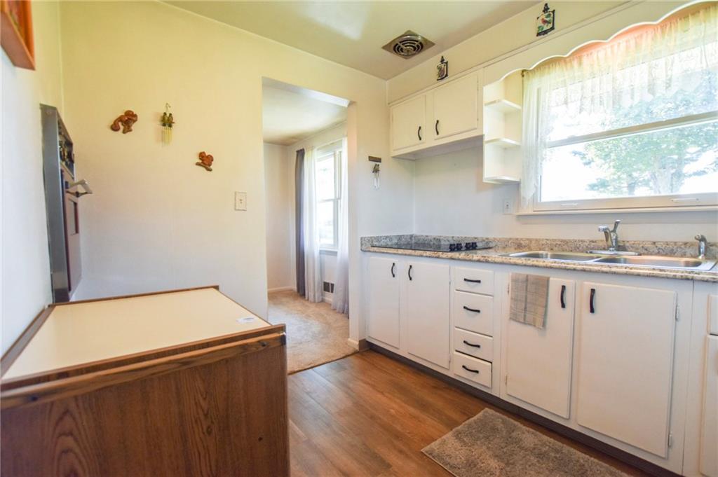 428 Dinnerbell Road Butler, PA 16002 - Photo 4 of 14 a kitchen with granite countertop white cabinets and white appliances
