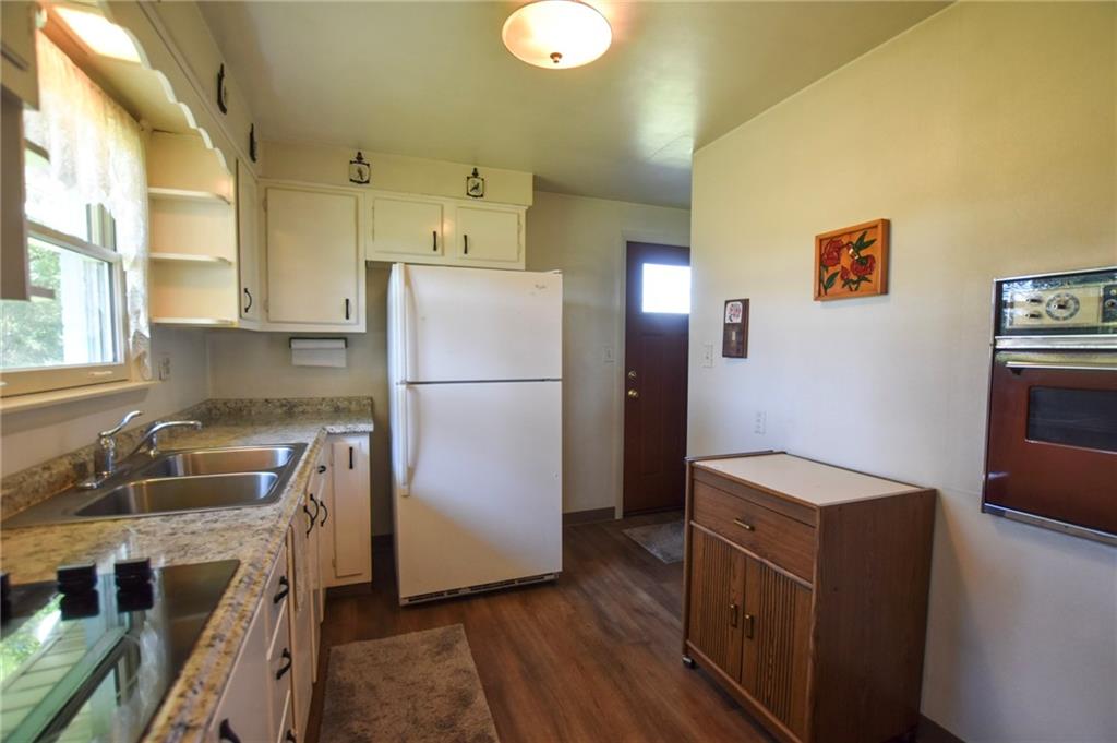 428 Dinnerbell Road Butler, PA 16002 - Photo 5 of 14 a kitchen with granite countertop a refrigerator and a sink