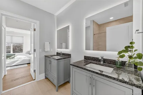 a living room with granite countertop a sink and a stove