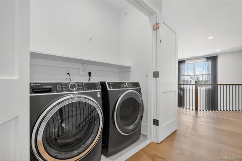 a view of a hallway with washer and dryer