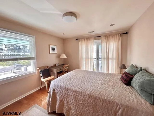a bedroom with a bed and a large window
